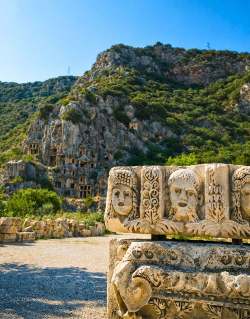 Inside ancient Myra Theatre with Lycian rock tombs and mountains above during Demre Myra Kekova Tour
