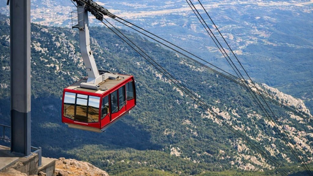olympos cable car gondola at the summit station with panoramic valley and coastline view