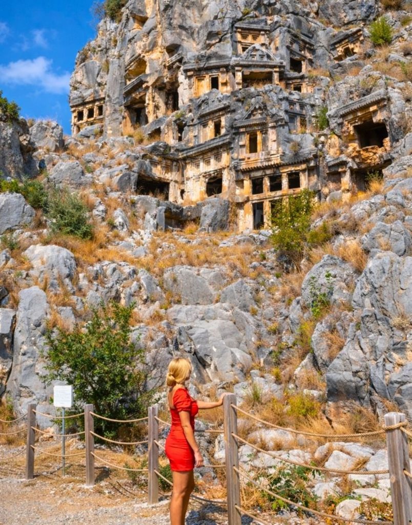 Visitor looking up at the Lycian rock tombs of Myra up close on Demre Myra Kekova tour