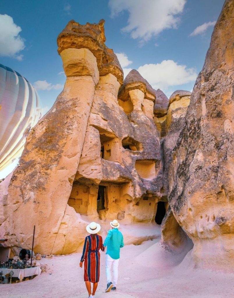Cappadocia fairy chimneys close up with hot air balloon and local craft stalls