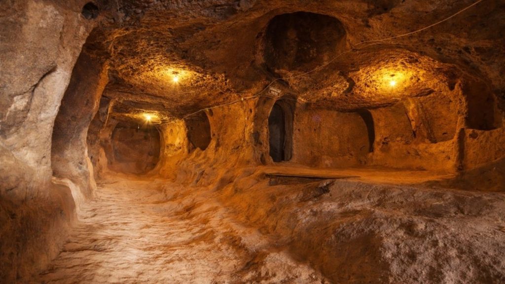 Cappadocia underground city ancient tunnels and carved rooms with warm lighting