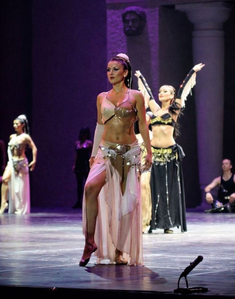 Solo female dancer in pink oriental costume performing at Fire of Anatolia show