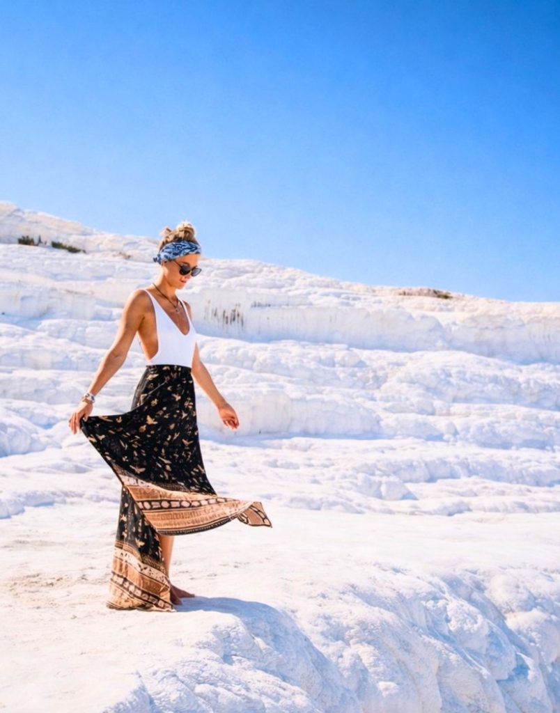 Pamukkale white calcium travertine terraces under bright blue sky Cotton Castle