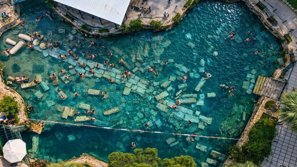Cleopatra Antique Pool aerial view with sunken Roman columns in thermal water Pamukkale