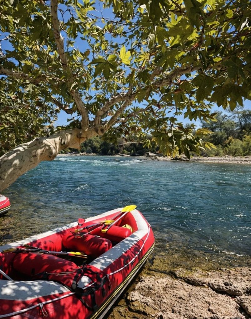 Antalya Koprulu Canyon rafting boat on crystal clear turquoise river under shady tree