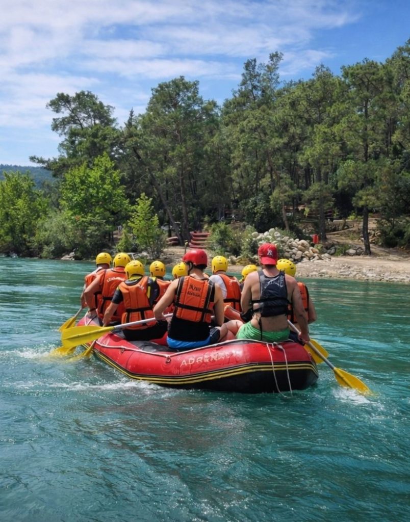 Antalya Koprulu Canyon rafting on calm turquoise water with pine forest scenery