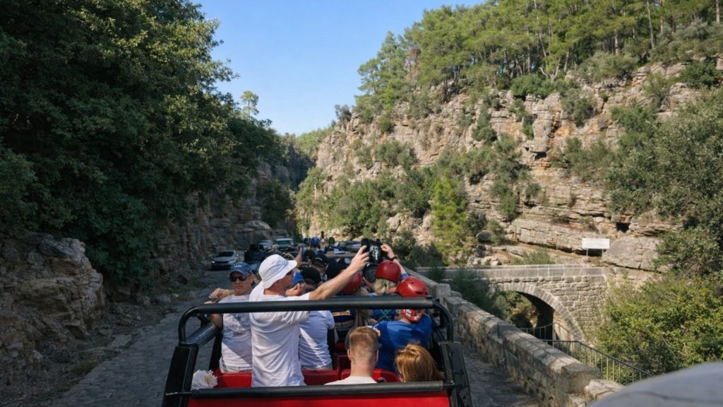 Antalya jeep safari driving through canyon road with ancient stone bridge and rock walls