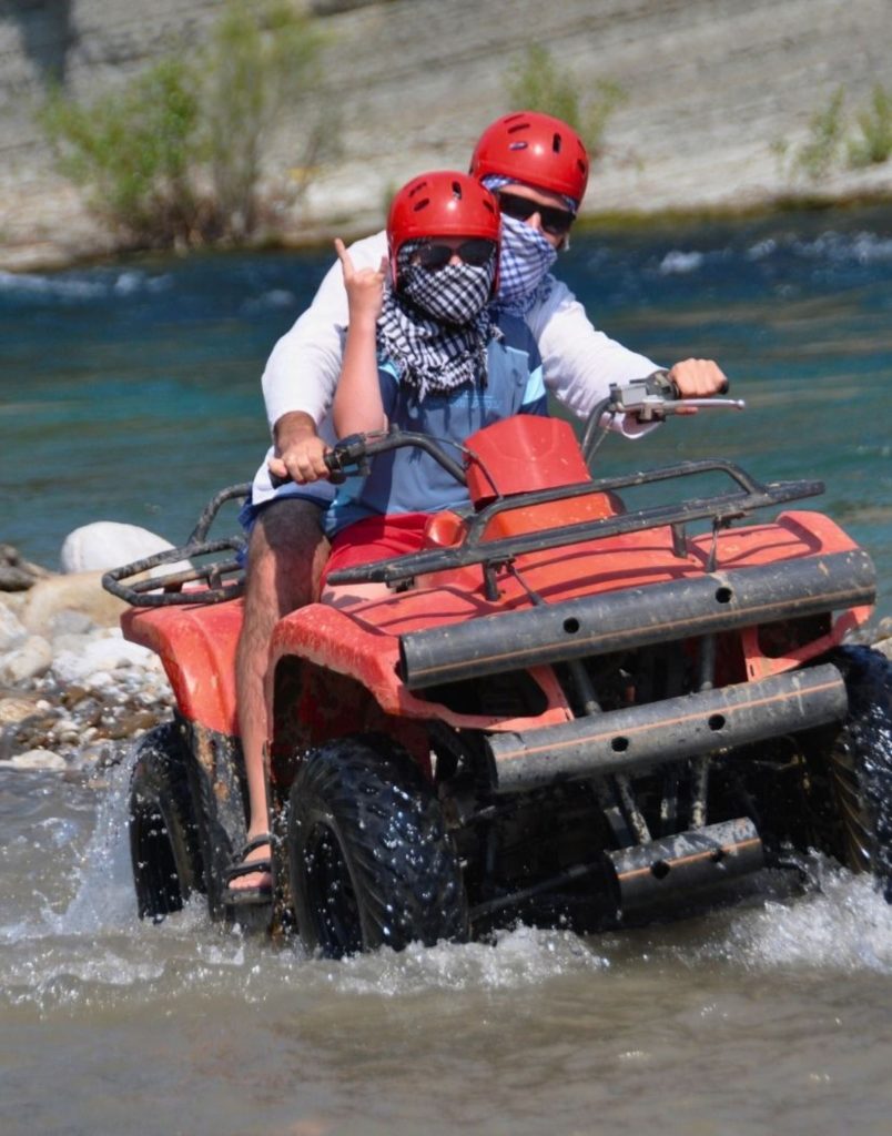 Quad bike crossing a river during Antalya Quad Safari and Rafting Tour adventure