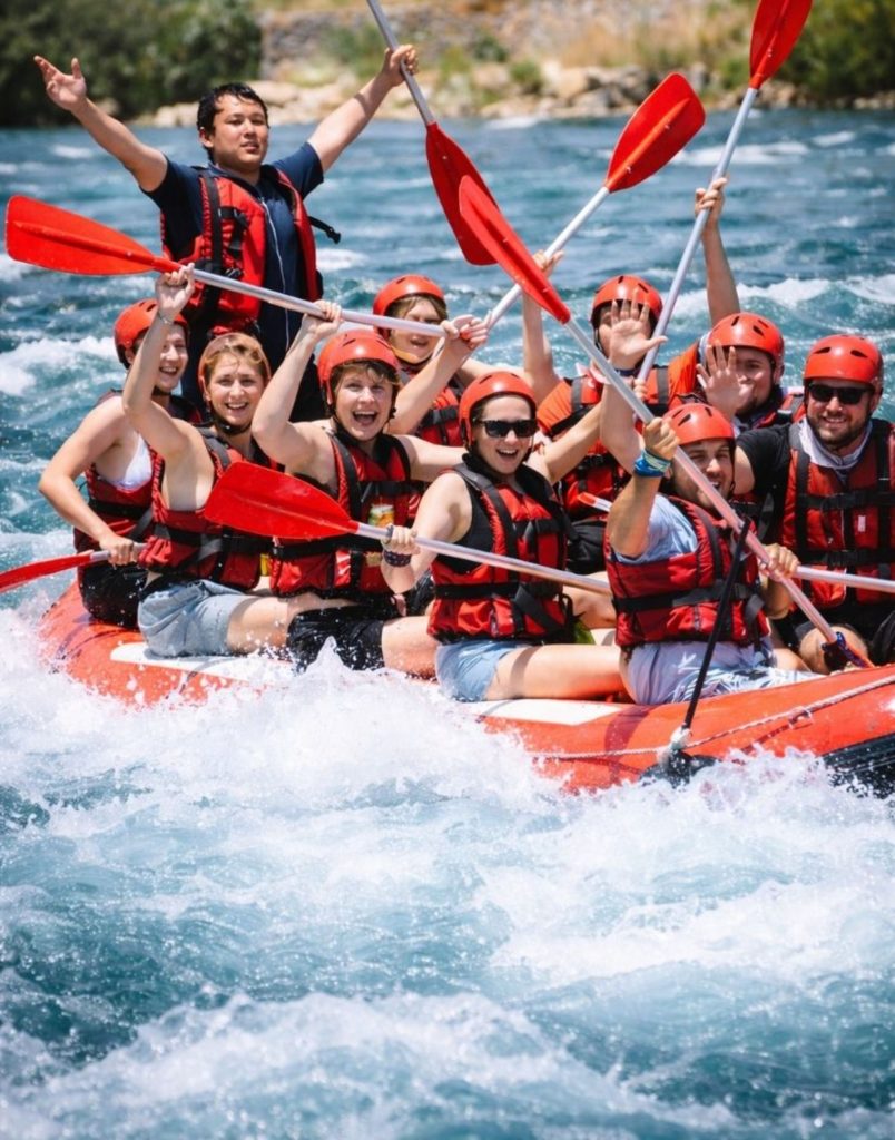 Rafting team celebrating with paddles raised on Koprulu Canyon during Antalya Quad Safari and Rafting Tour