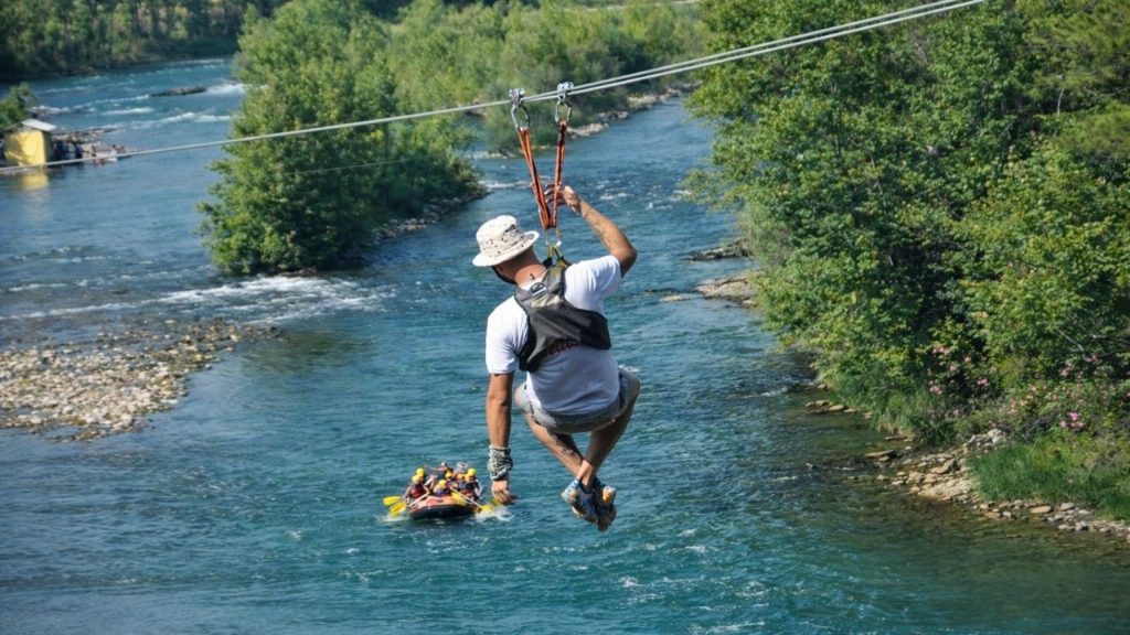 Antalya zipline over turquoise Koprulu Canyon river with rafting boat passing below