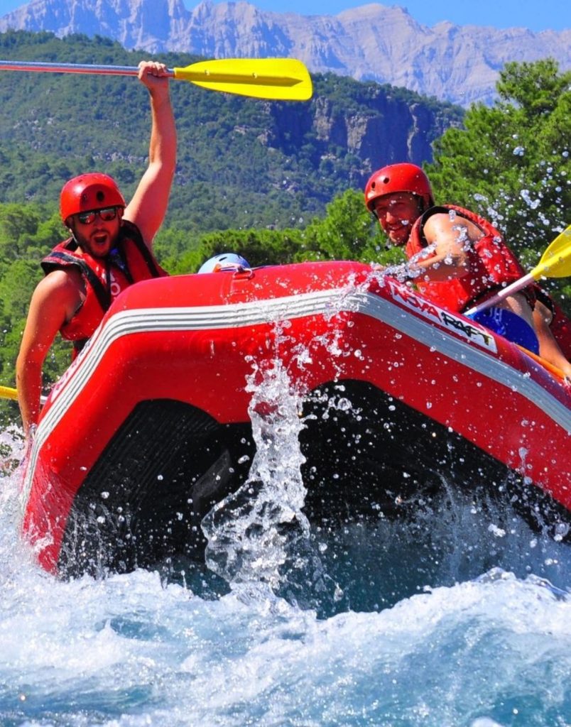 Antalya Koprulu Canyon rafting action with paddle up and Taurus Mountains in background