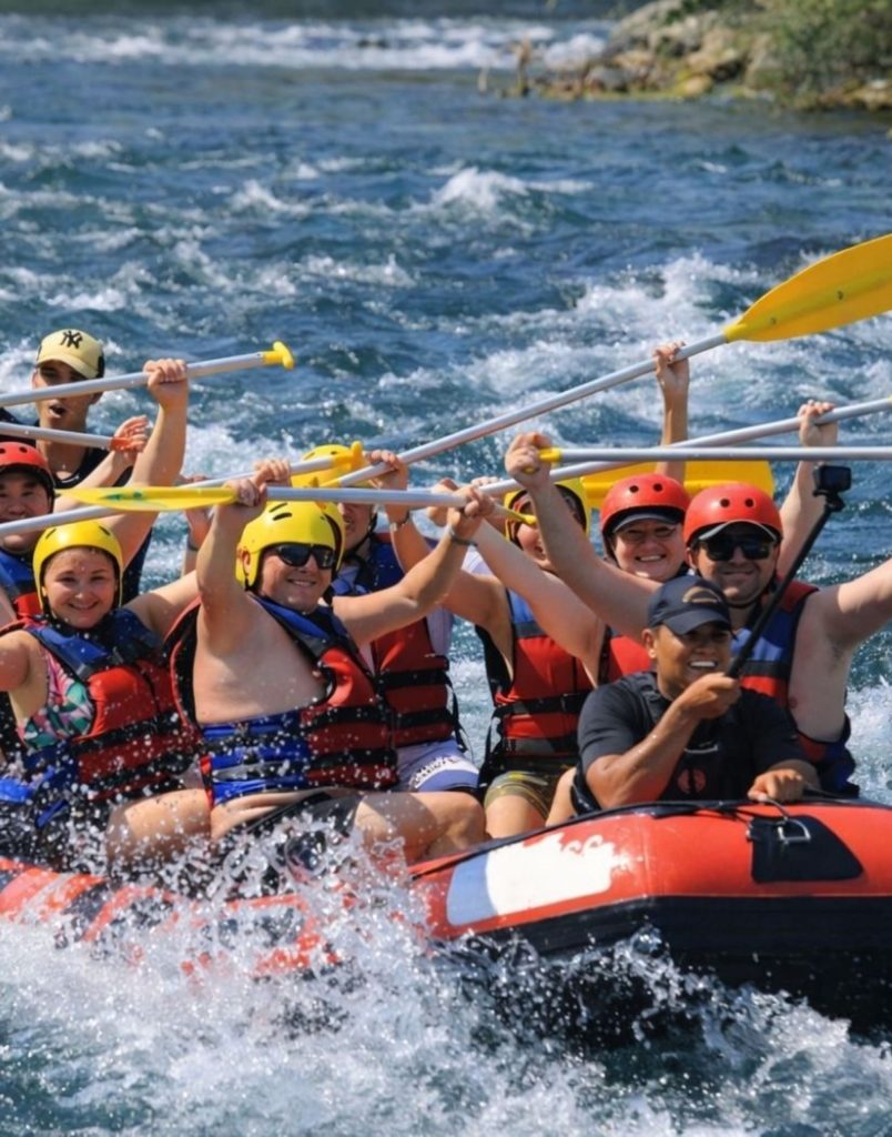 Rafting team with paddles raised on Koprulu Canyon white water rapids in Antalya