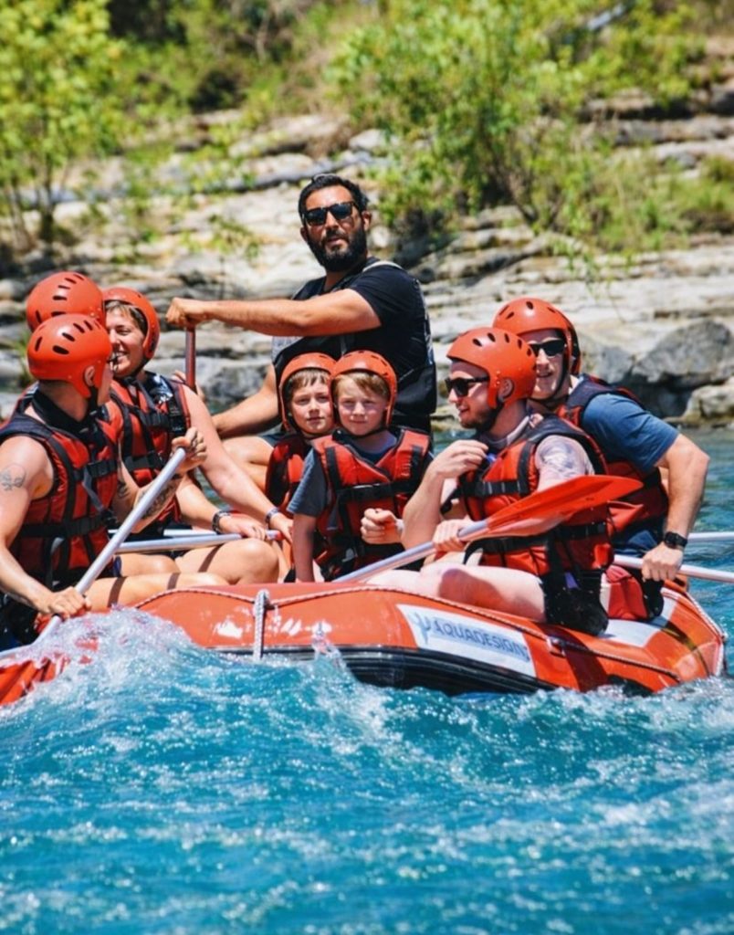 Family with kids rafting on turquoise Koprulu Canyon water during Antalya Rafting and Zipline Tour