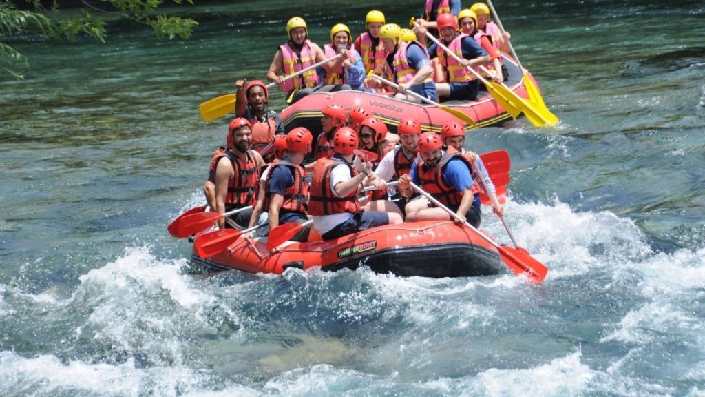 Two rafting boats racing through Koprulu Canyon rapids during Antalya Rafting and Zipline Tour