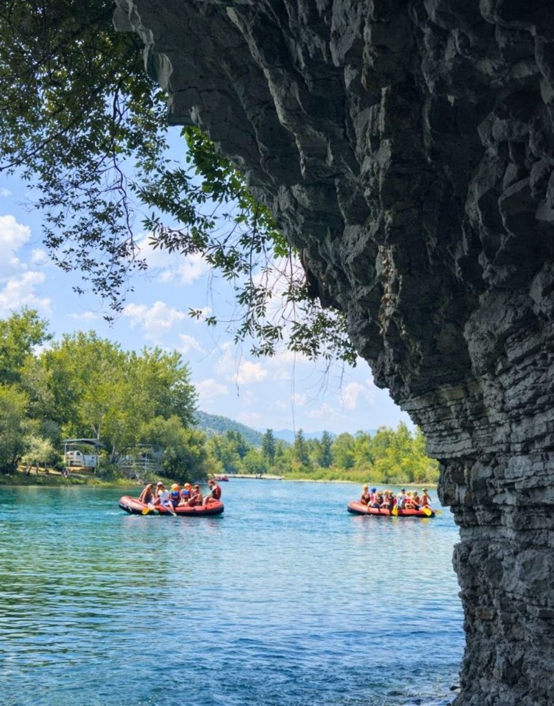 Rafting under natural rock arch on turquoise Koprulu Canyon water during Antalya Tazi Canyon Jeep Safari and Rafting Tour