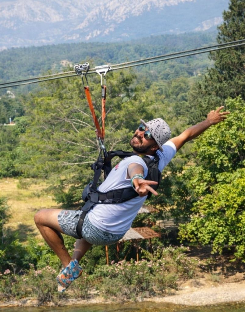 Zipline adventure with Taurus Mountains in background during Antalya Tazi Canyon Jeep Safari Zipline and Rafting Tour