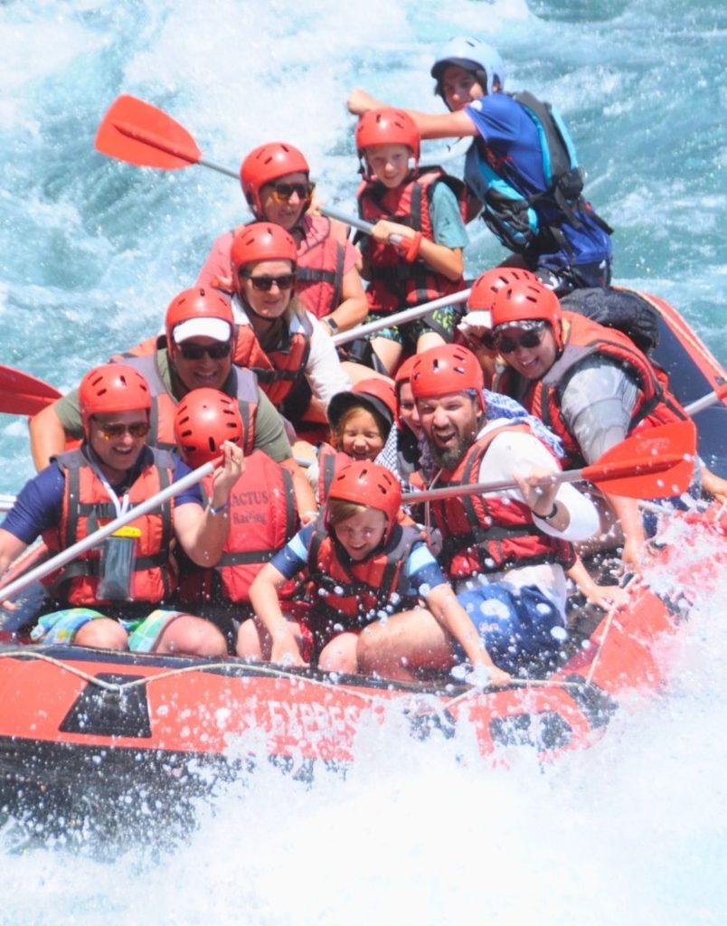 Close-up of laughing tourists rafting through white water rapids at Koprulu Canyon Antalya